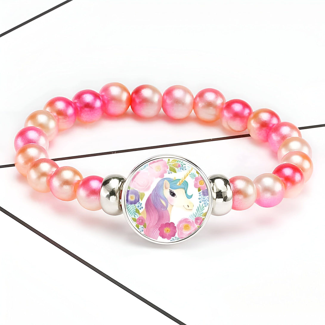 Bracelet enfant avec perles roses et pendentif licorne colorée entourée de fleurs. Accessoire de mode fantaisie pour filles., 45501422829823 | Licorne Shop