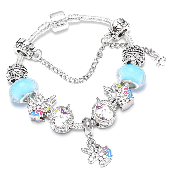 Bracelet breloque argenté avec des perles bleues et des pendentifs licorne émaillés multicolores. Bijou fantaisie idéal pour un cadeau féerique., 45501422043391 | Licorne Shop