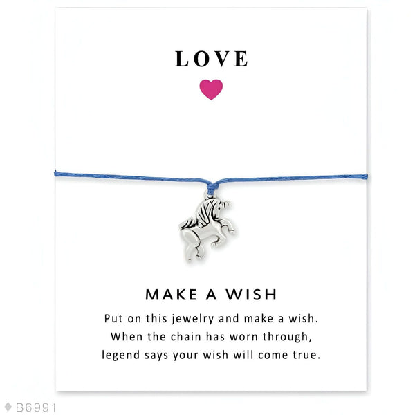 Bracelet bleu "Faites un vœu" avec un pendentif licorne argentée, présenté sur une carte blanche avec le mot "LOVE" et un cœur rose. Bijou de souhait porte-bonheur., 45501397827839 | Licorne Shop
