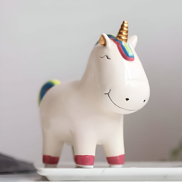 Figurine d'un licorne souriant en céramique blanche avec une corne dorée et une crinière et queue arc-en-ciel., 45501186441471 | Licorne Shop