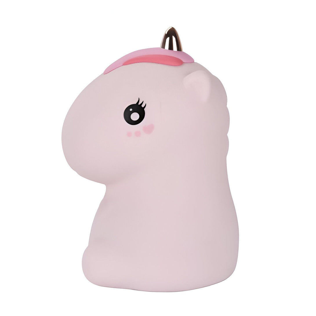 Une veilleuse licorne en silicone rose avec une corne et une crinière rose.