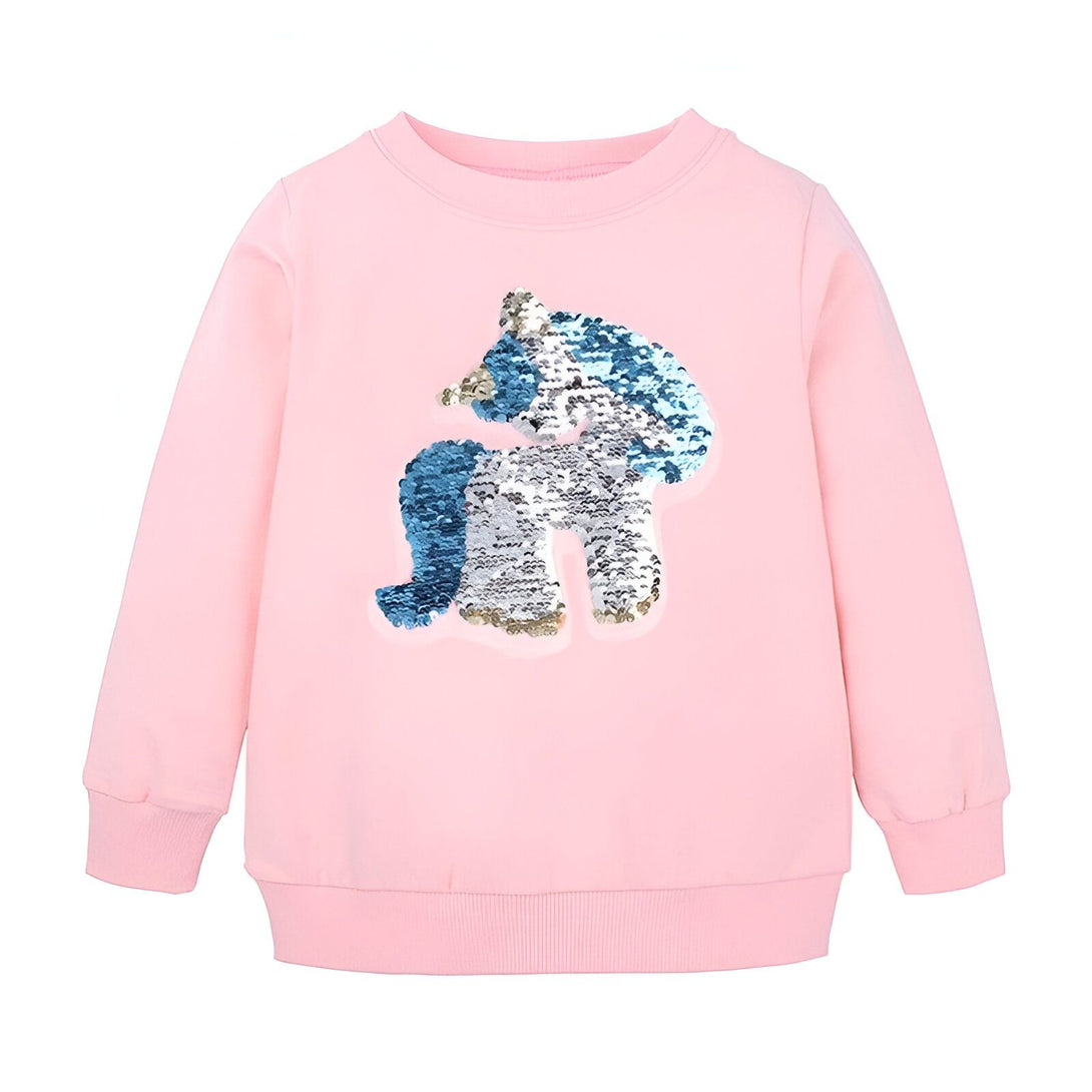 Une image d'un sweat-shirt rose pour enfant avec une licorne à paillettes réversibles bleu et argent.