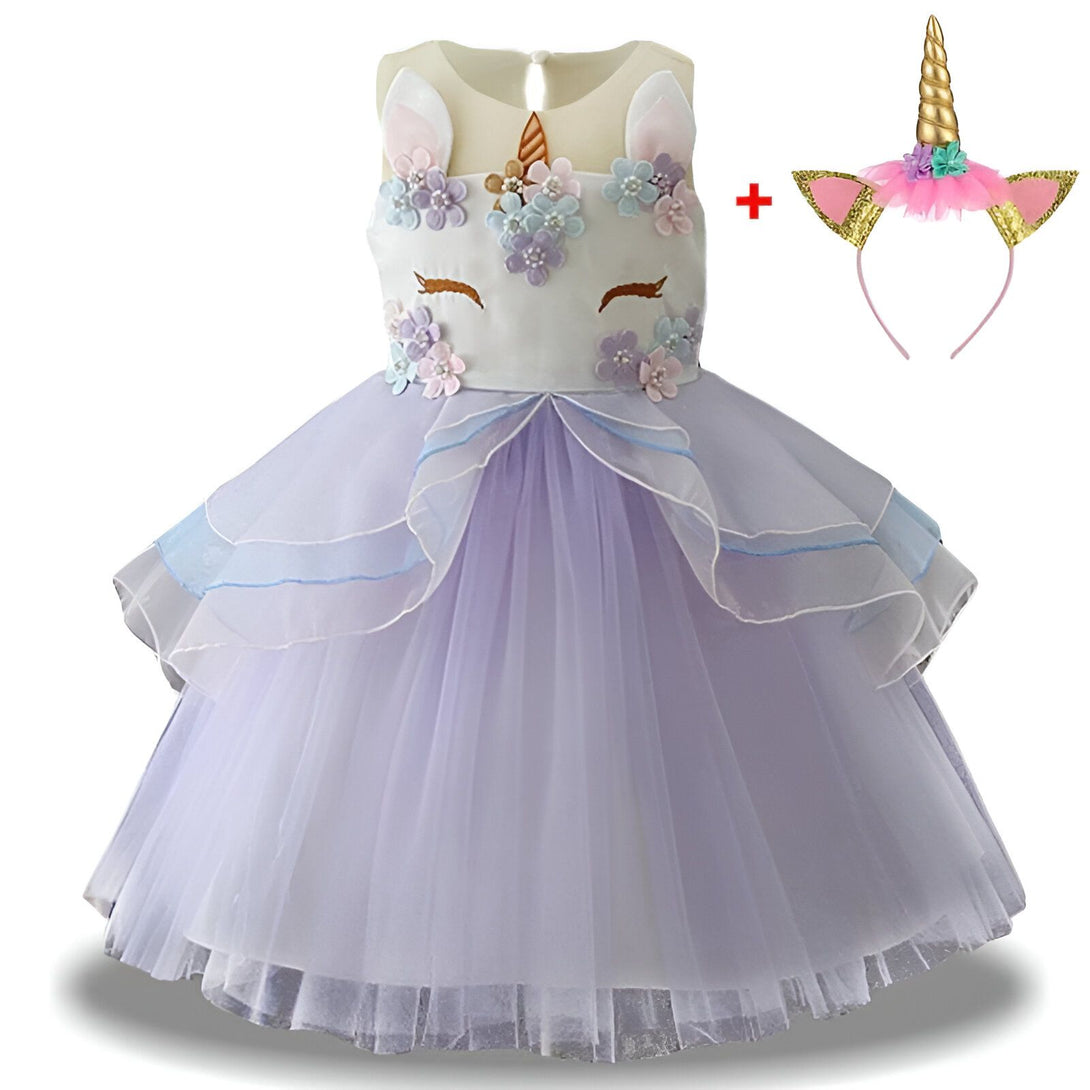 Une robe de licorne blanche et violette avec des fleurs et des paillettes. La robe est livrée avec un serre-tête avec une corne de licorne.