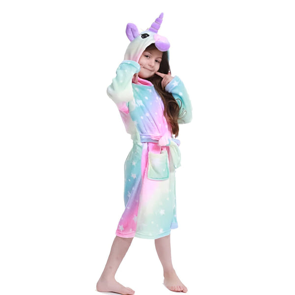 Une petite fille souriante porte un peignoir licorne coloré., 45502344724735,45502344757503,45502344790271,45502344823039,45502344855807,45502344888575,45502344921343,45502344954111 | Licorne Shop