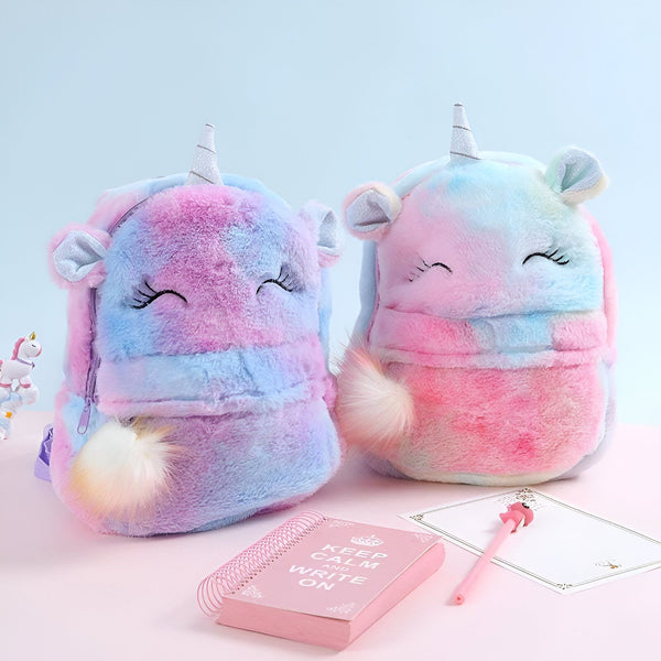 Deux sacs à dos en peluche licorne arc-en-ciel avec des yeux fermés et une crinière et une queue colorées.