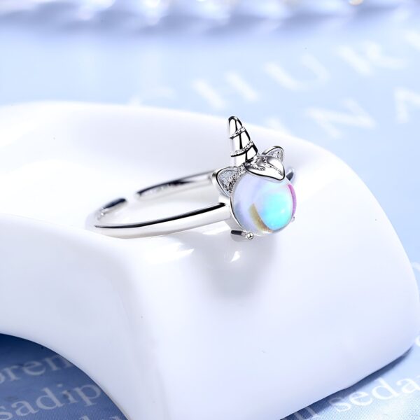 Une bague en argent avec un motif de licorne. La licorne a une crinière et une queue arc-en-ciel. La bague est ajustable.