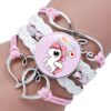 Bracelet fantaisie multicolore avec motif licorne sur un poignet. Il a des breloques en forme de cœur et le symbole de l'infini. C'est un accessoire de mode mignon pour les filles et les femmes., 45501372039423 | Licorne Shop
