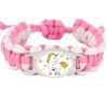 bracelet-en-paracorde-motif-licorne-1a.jpg Bracelet tressé rose et blanc pour enfant avec un pendentif licorne entourée d'étoiles et de papillons. Accessoire de mode mignon et coloré pour les jeunes filles., 45501422436607 | Licorne Shop