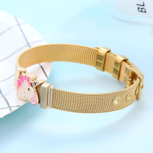 Un bracelet en acier inoxydable doré avec un pendentif licorne rose et coloré.