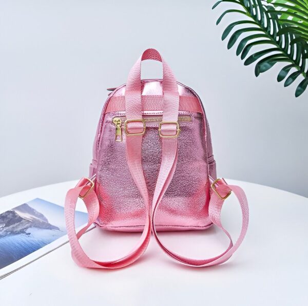 cartable-licorne-arc-en-ciel-rose-2a Un sac à dos rose en cuir avec des bretelles réglables et une fermeture éclair sur le devant.