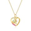 collier-licorne-femme-or-2a.jpg Un collier avec un pendentif en forme de cœur en or avec une licorne colorée. Le pendentif est serti de strass et l'inscription "life is beautiful" est gravée sur le cœur.