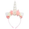 Un serre-tête licorne avec des fleurs roses et blanches.